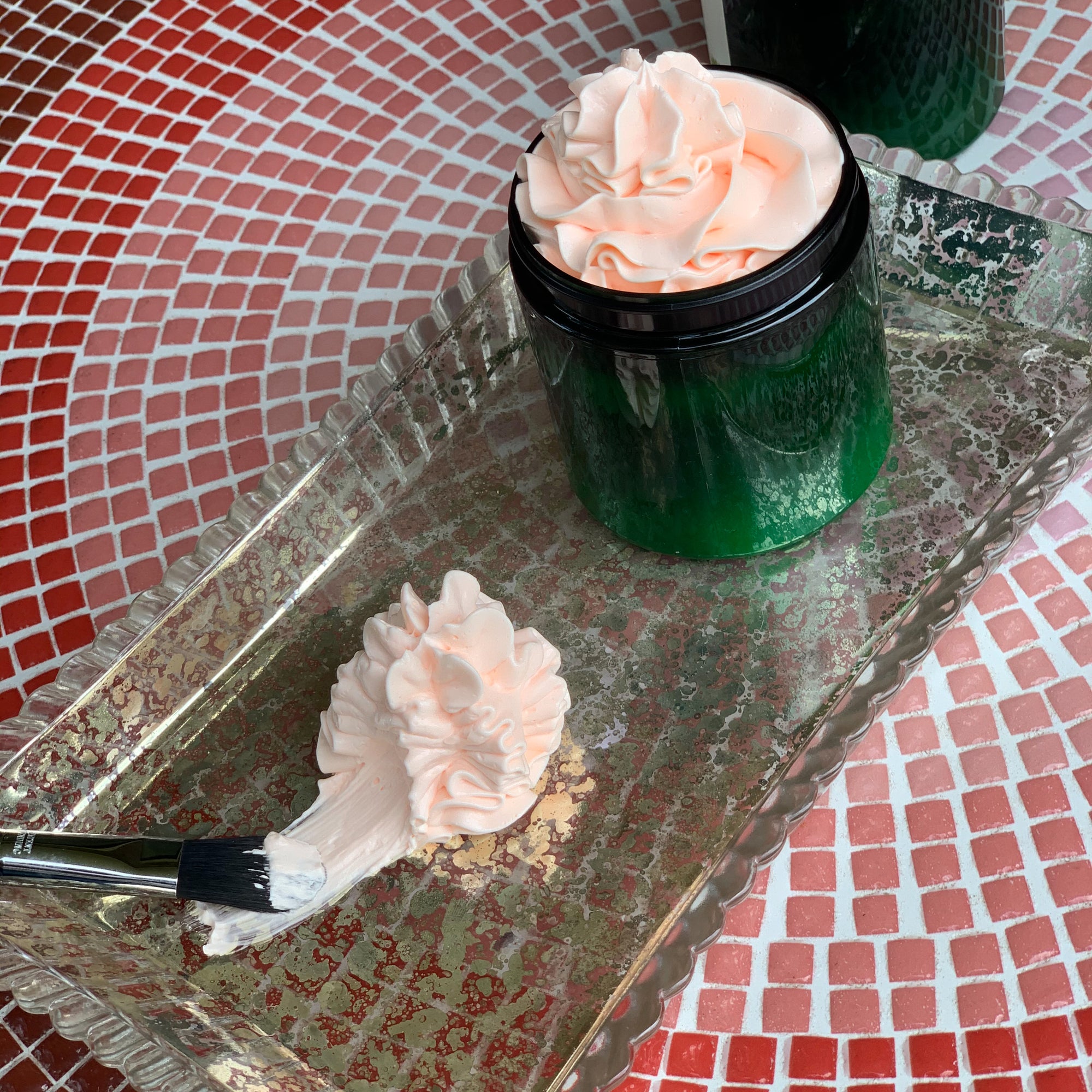 A jar of Tahami By Nature’s Whipped Body Butter with a rich, creamy texture. The luxurious body butter is made with natural ingredients like shea butter and coconut oil, perfect for moisturizing and protecting dry winter skin.